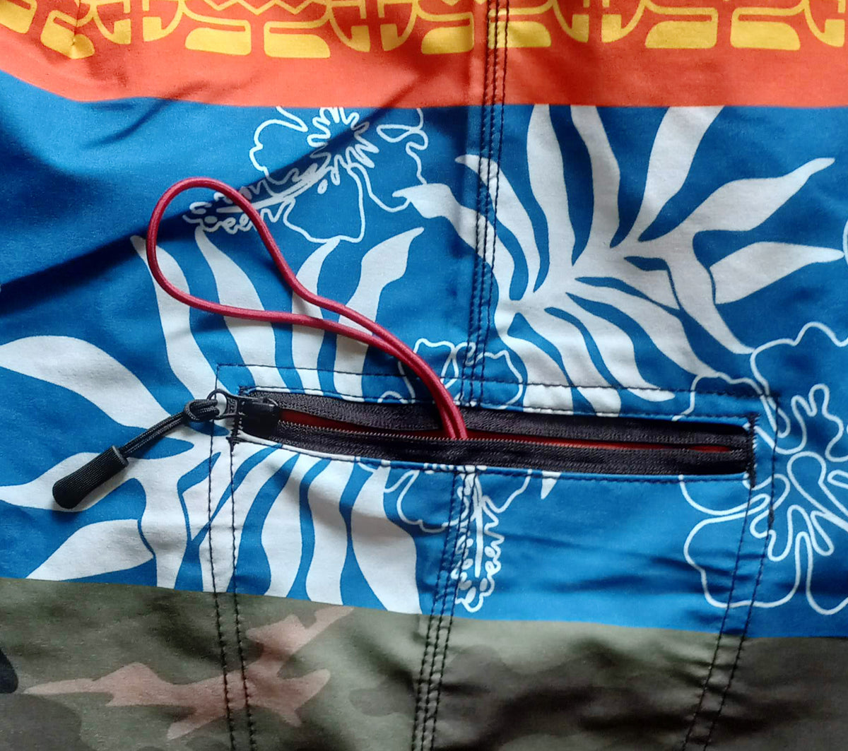 Close-up of the side zipper pocket on HIC Ua Huka board shorts