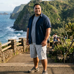 HIC Mauna Kea cargo walking shorts in Stone showing the side cargo pocket, worn on a coastal trail