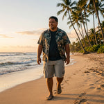 HIC Mauna Kea men's cargo walking shorts in Stone on a Hawaii beach at sunset