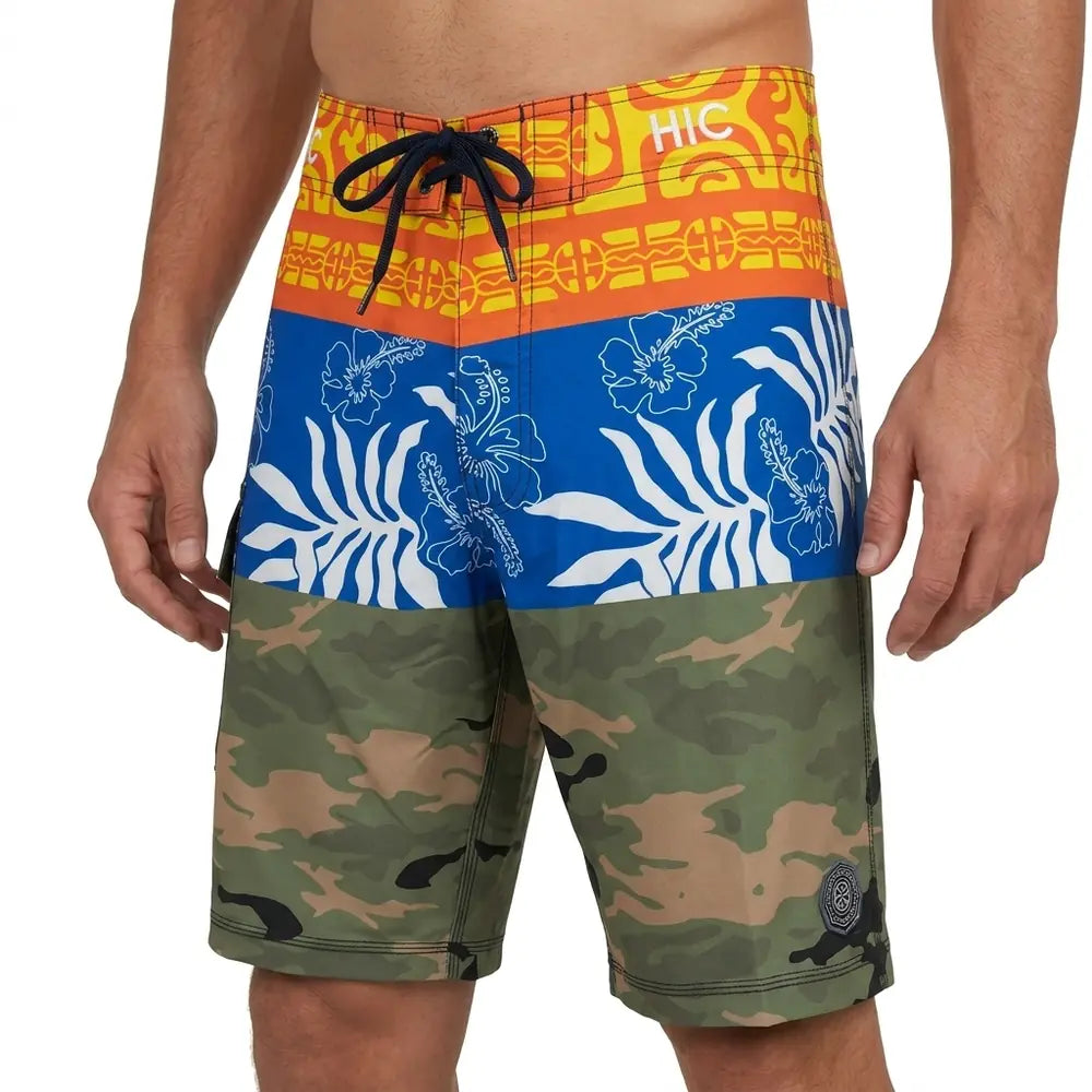 Front of HIC Ua Huka board shorts: orange Marquesan motifs, white florals on blue, and camo
